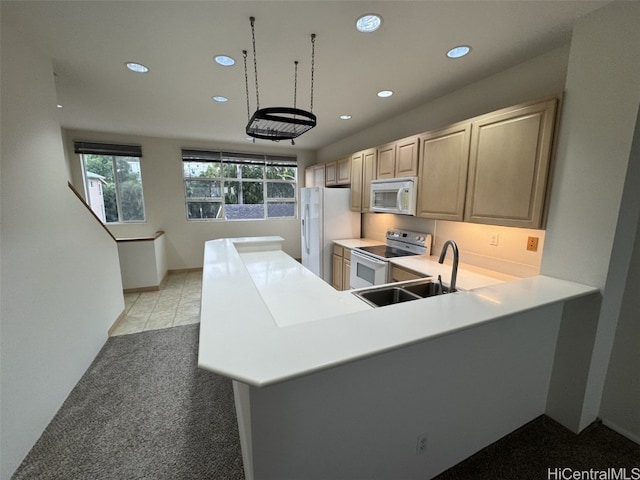 kitchen with kitchen peninsula, light brown cabinetry, white appliances, and sink