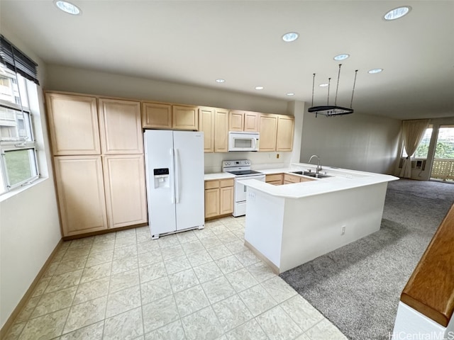 kitchen with white appliances, a kitchen island with sink, sink, light brown cabinets, and decorative light fixtures