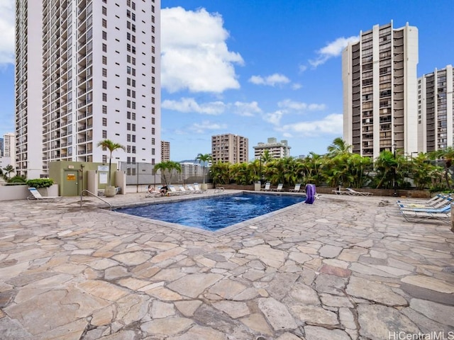 view of pool with a patio area and pool water feature