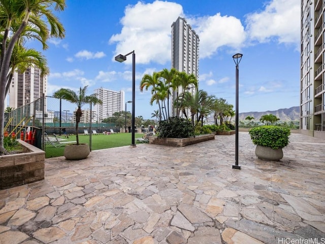 surrounding community featuring a mountain view and a patio