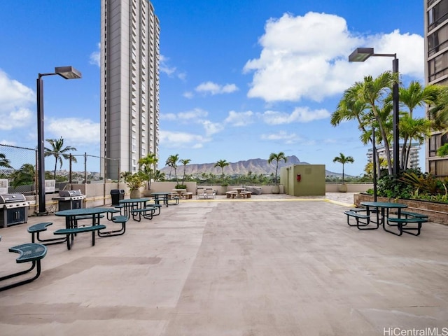 view of property's community with a mountain view and a patio area