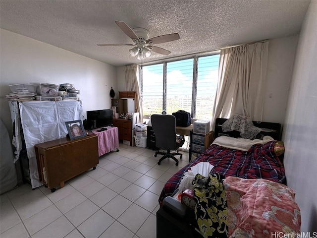 bedroom featuring a textured ceiling, ceiling fan, and light tile patterned flooring