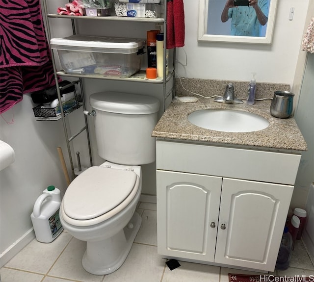 bathroom with vanity, tile patterned floors, and toilet