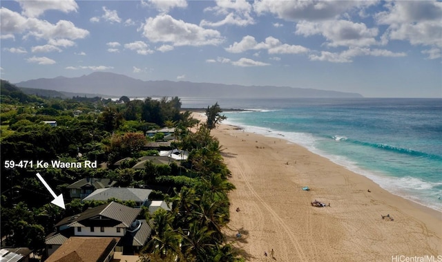 water view with a mountain view and a view of the beach