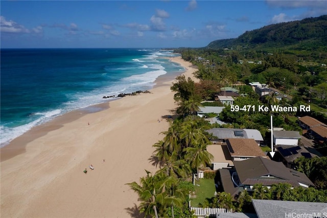 birds eye view of property featuring a water view and a beach view