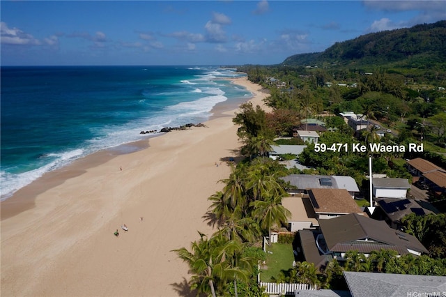 birds eye view of property featuring a beach view and a water view