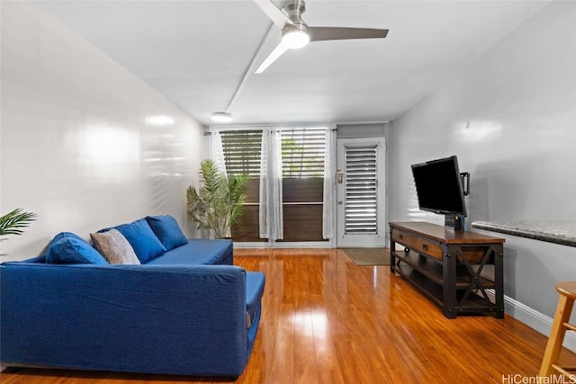 living room with hardwood / wood-style floors and ceiling fan