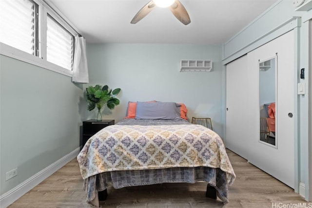 bedroom featuring light hardwood / wood-style floors, a closet, and ceiling fan