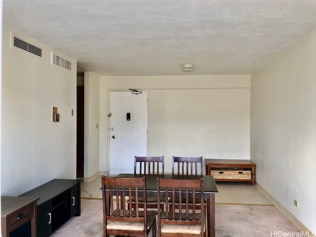 dining space with light colored carpet