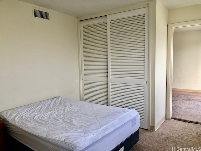 bedroom with light colored carpet and a closet