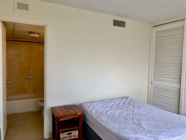 bedroom featuring ensuite bathroom and a closet