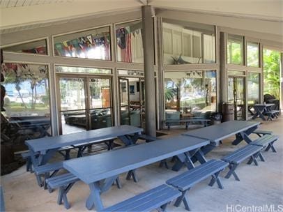 exterior space featuring french doors, a healthy amount of sunlight, and vaulted ceiling