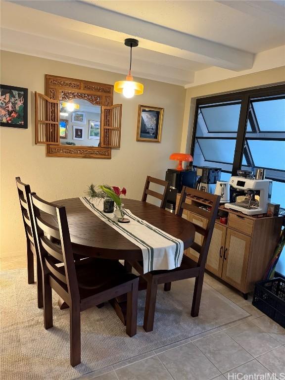 tiled dining space with beam ceiling