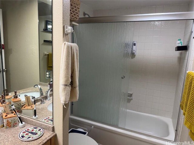 full bathroom with vanity, toilet, and bath / shower combo with glass door