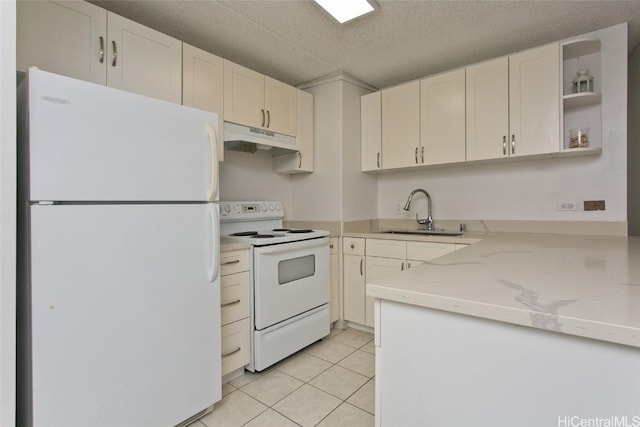 kitchen with white cabinetry, sink, light tile patterned floors, light stone counters, and white appliances