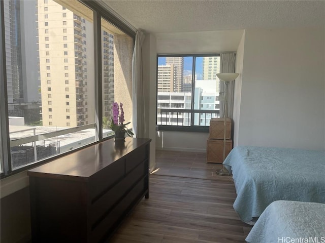 bedroom featuring dark hardwood / wood-style floors and a textured ceiling