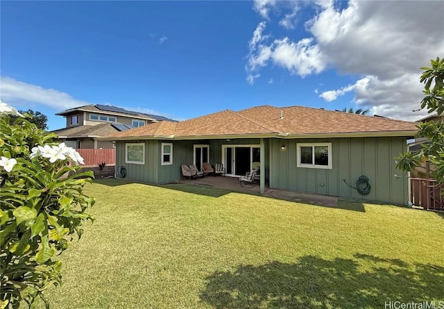 back of house with a yard and a patio area