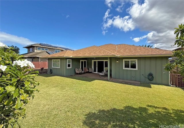 rear view of property with a yard and a patio