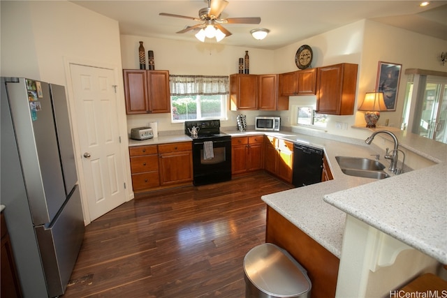 kitchen with sink, dark hardwood / wood-style flooring, kitchen peninsula, a breakfast bar, and black appliances