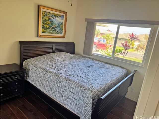 bedroom with dark hardwood / wood-style flooring