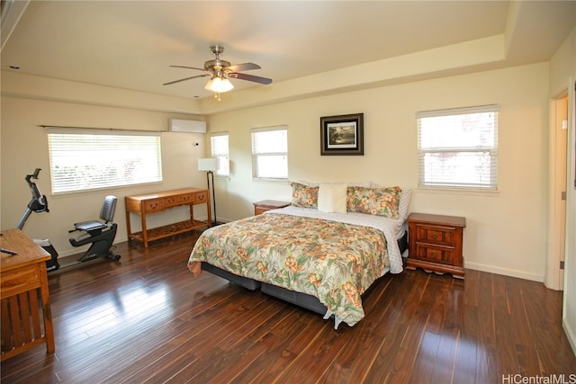 bedroom with multiple windows, dark hardwood / wood-style flooring, and ceiling fan