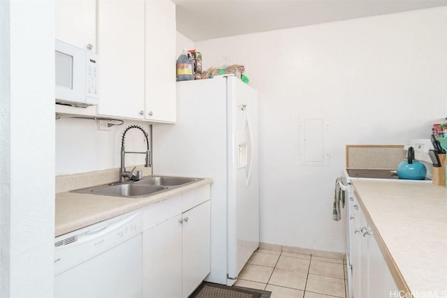 kitchen featuring light tile patterned flooring, white appliances, white cabinetry, and sink