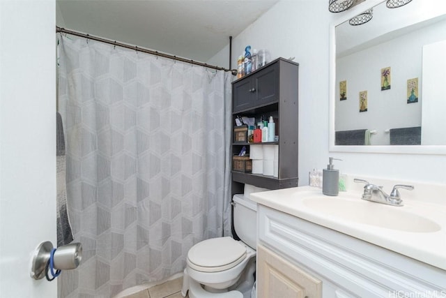 bathroom featuring tile patterned floors, vanity, and toilet