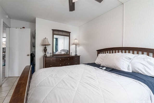 bedroom featuring ceiling fan, light tile patterned floors, and lofted ceiling