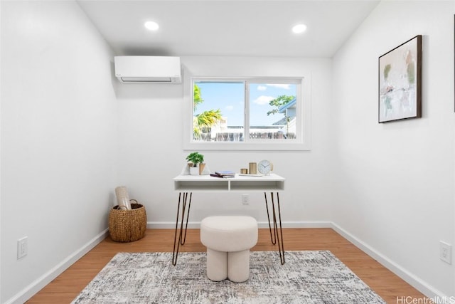 office with hardwood / wood-style floors and a wall mounted AC