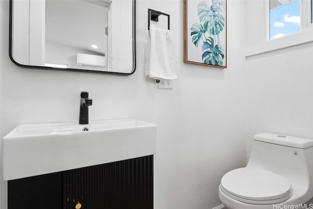 bathroom featuring toilet and vanity