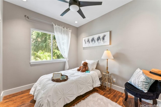 bedroom with hardwood / wood-style floors and ceiling fan