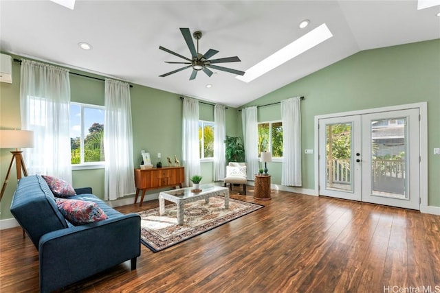 living area featuring ceiling fan, dark hardwood / wood-style flooring, lofted ceiling with skylight, and french doors