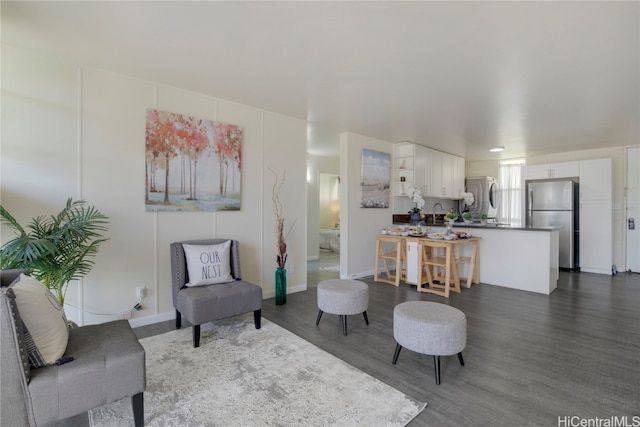 living room with dark hardwood / wood-style flooring