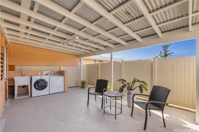 view of patio / terrace with separate washer and dryer and sink