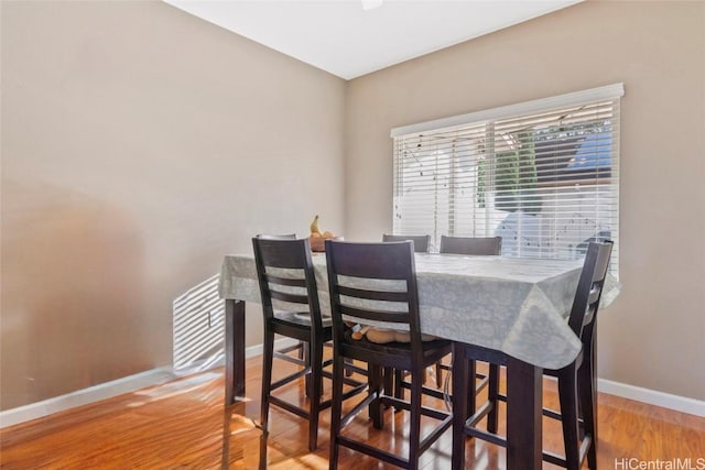 dining area with hardwood / wood-style flooring