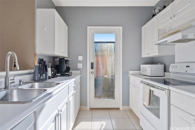 kitchen featuring light countertops, light tile patterned floors, white appliances, white cabinetry, and a sink