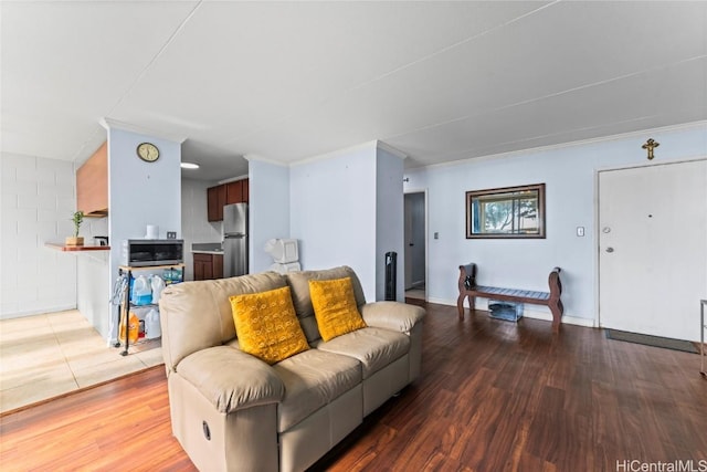 living room with crown molding and wood-type flooring