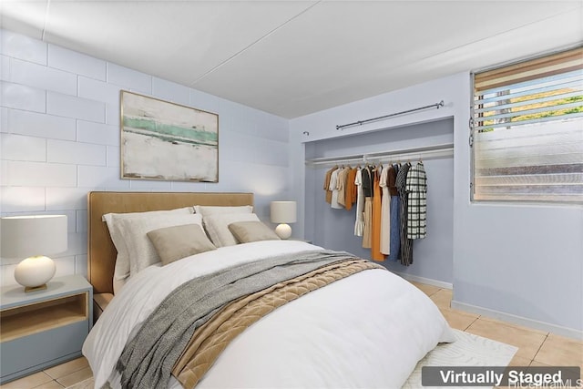 tiled bedroom with a closet