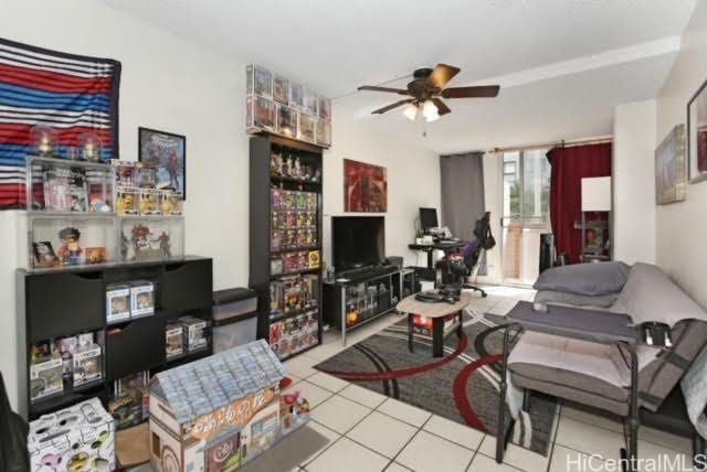 tiled living room featuring ceiling fan