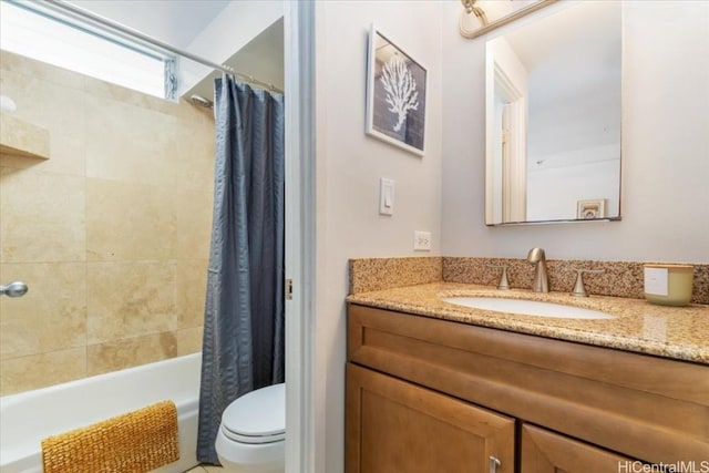 full bathroom featuring toilet, vanity, and shower / tub combo with curtain