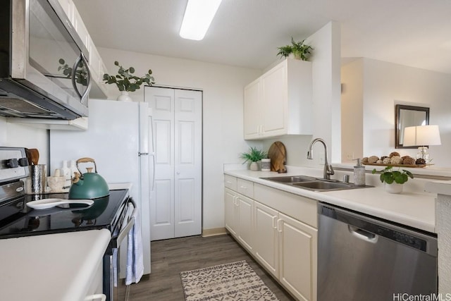 kitchen with white cabinetry, sink, dark wood-type flooring, and appliances with stainless steel finishes