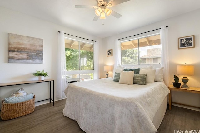 bedroom with ceiling fan and dark wood-type flooring