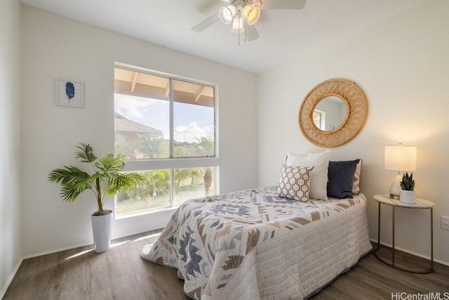 bedroom with ceiling fan and dark hardwood / wood-style flooring