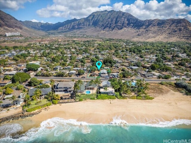 bird's eye view with a water and mountain view and a view of the beach