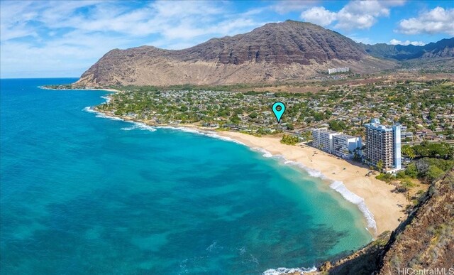 drone / aerial view with a water and mountain view