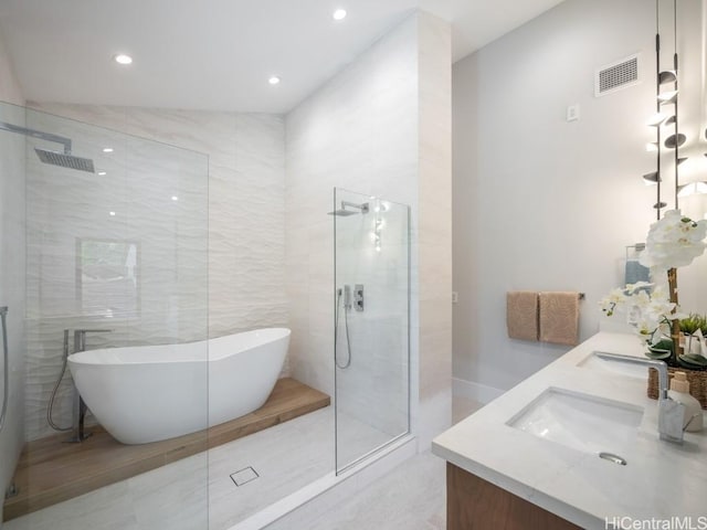 bathroom with vanity, lofted ceiling, and independent shower and bath