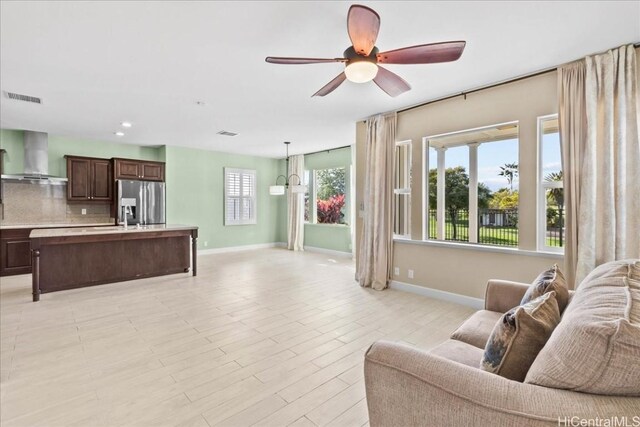 living room featuring ceiling fan and light hardwood / wood-style floors