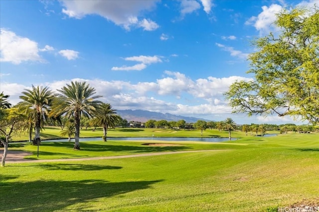 surrounding community featuring a lawn and a water and mountain view