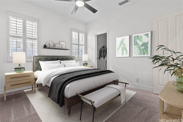 carpeted bedroom featuring a closet, a spacious closet, and ceiling fan