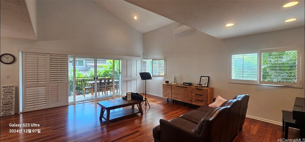 living room featuring dark hardwood / wood-style flooring, high vaulted ceiling, and an AC wall unit